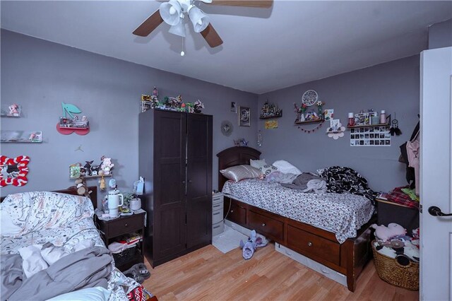 bedroom with ceiling fan and light wood-type flooring