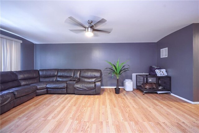 living room with ceiling fan and light hardwood / wood-style floors