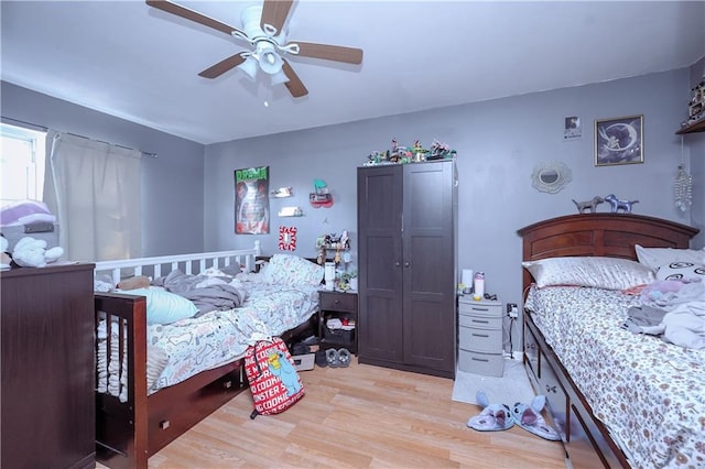 bedroom with ceiling fan and light hardwood / wood-style flooring