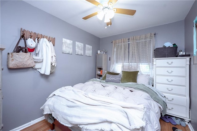 bedroom with wood-type flooring and ceiling fan