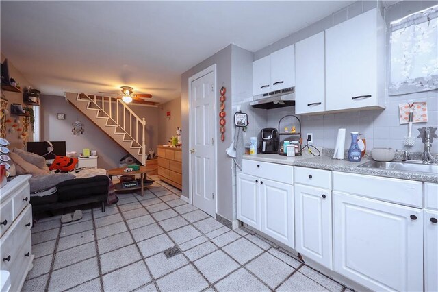 kitchen featuring white cabinetry, sink, ceiling fan, and tasteful backsplash