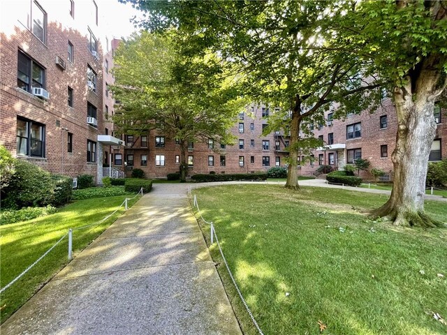 view of property's community with a lawn