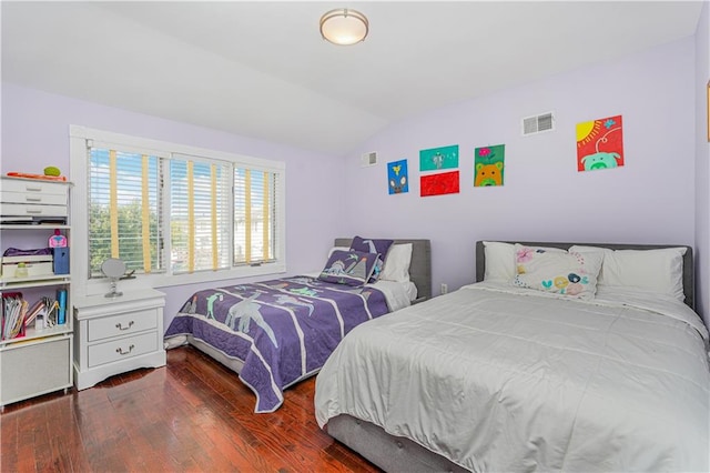 bedroom with vaulted ceiling and dark hardwood / wood-style floors