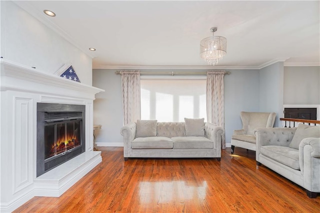 unfurnished living room with wood-type flooring, an inviting chandelier, and crown molding