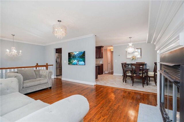 living room featuring hardwood / wood-style flooring and ornamental molding