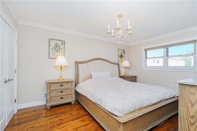 bedroom with dark hardwood / wood-style floors, a closet, and crown molding