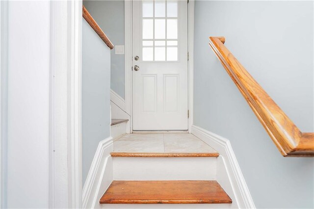 stairway with tile patterned floors