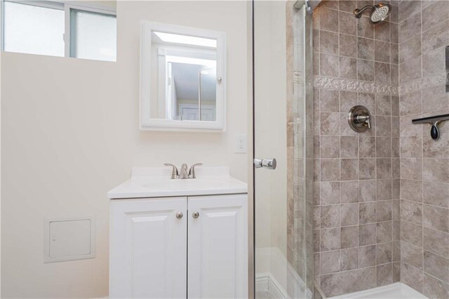 bathroom featuring vanity and a tile shower