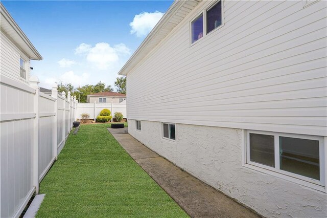 view of side of home featuring a yard