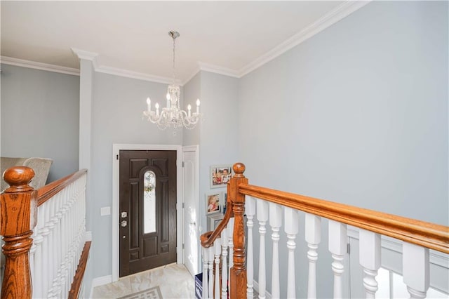 entryway with crown molding and a chandelier