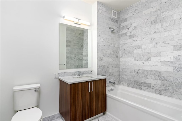 full bathroom featuring tiled shower / bath combo, vanity, and toilet