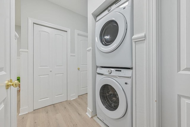 184 Hull St Unit C, Brooklyn, NY 11233 - washroom with stacked washer and clothes dryer and light wood finished floors