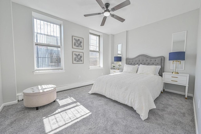 carpeted bedroom featuring ceiling fan, baseboards, and a baseboard radiator