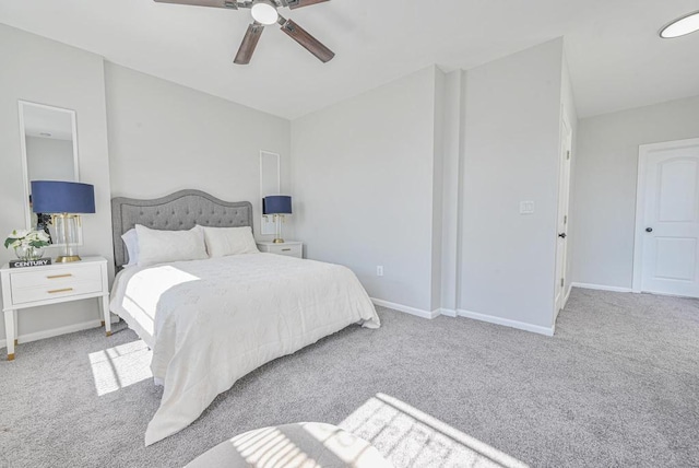 carpeted bedroom with baseboards and a ceiling fan