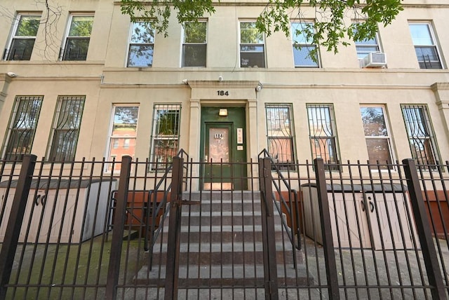 exterior space featuring cooling unit and a fenced front yard