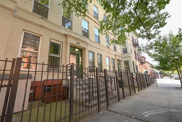 view of property featuring a residential view and fence