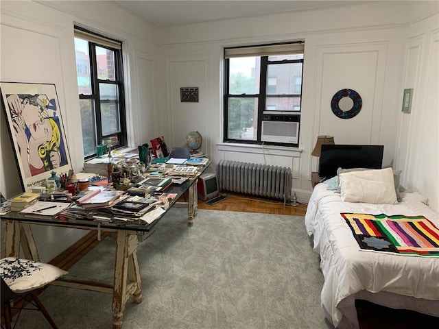 402 Bay Ridge Parkway Unit 42, Brooklyn, NY 11209 - bedroom with radiator heating unit, a decorative wall, multiple windows, and cooling unit