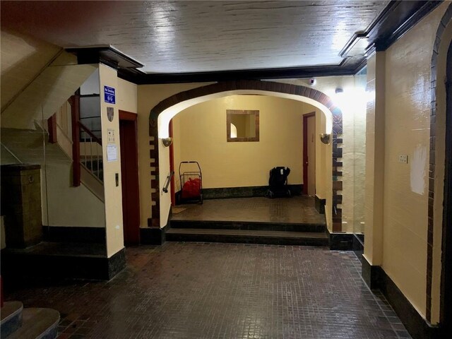 402 Bay Ridge Parkway Unit 42, Brooklyn, NY 11209 - hall featuring stairway, arched walkways, brick patterned flooring, and baseboards