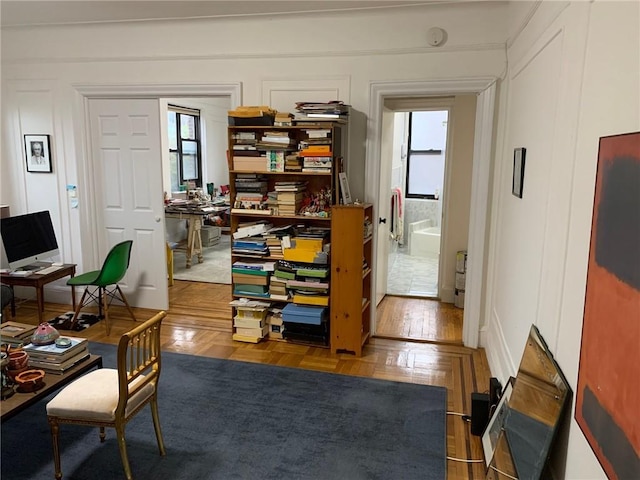 office with a healthy amount of sunlight and parquet flooring