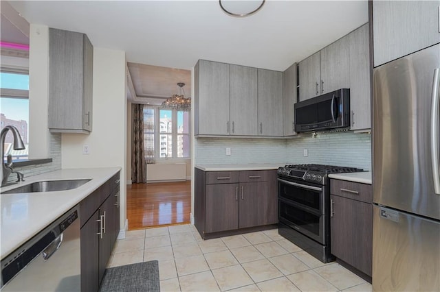 kitchen featuring a sink, stainless steel appliances, and light countertops