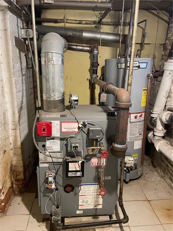 utility room featuring gas water heater