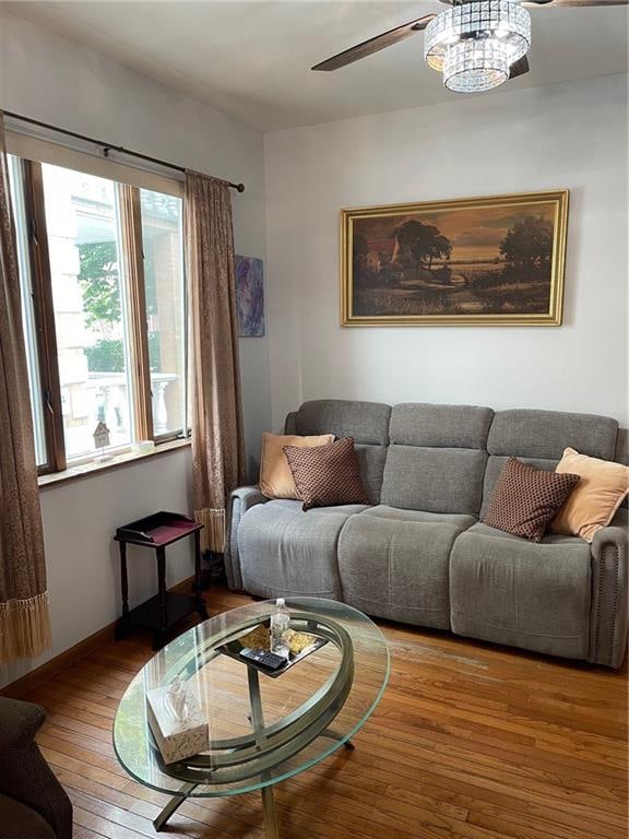 living room with ceiling fan and hardwood / wood-style floors