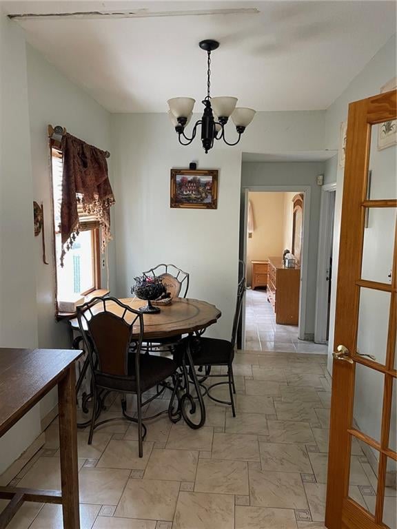 dining area with an inviting chandelier