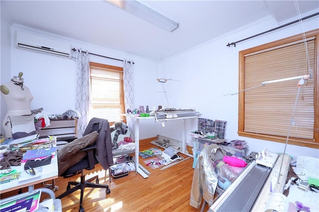 office area with wood finished floors, crown molding, and a wall mounted AC