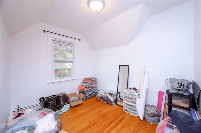 additional living space with vaulted ceiling and wood finished floors