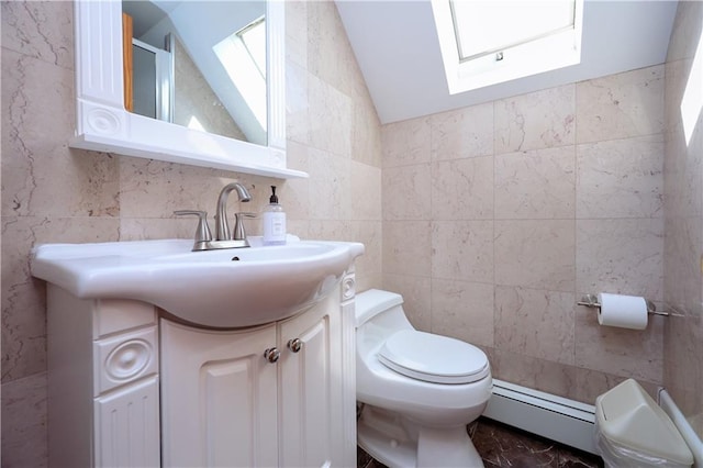 bathroom with vaulted ceiling with skylight, toilet, tile walls, and a baseboard radiator