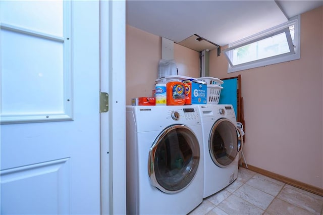 laundry area featuring washing machine and clothes dryer