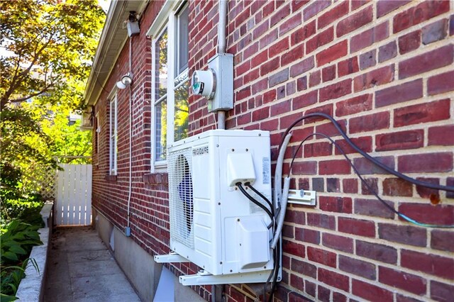 view of side of home with ac unit