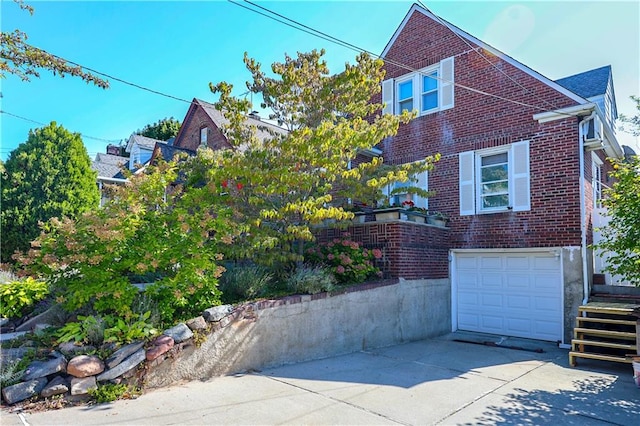 view of front of house featuring a garage, brick siding, and concrete driveway