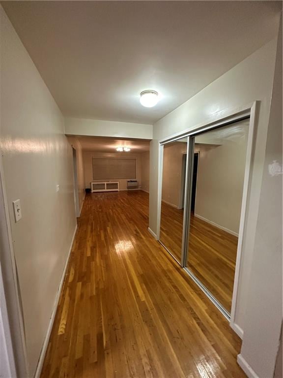 corridor with wood-type flooring