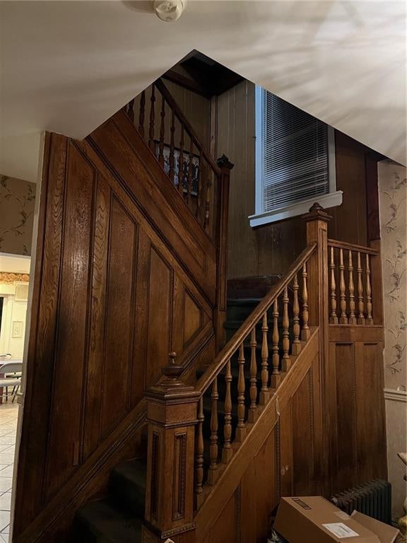 stairway with wooden walls and radiator