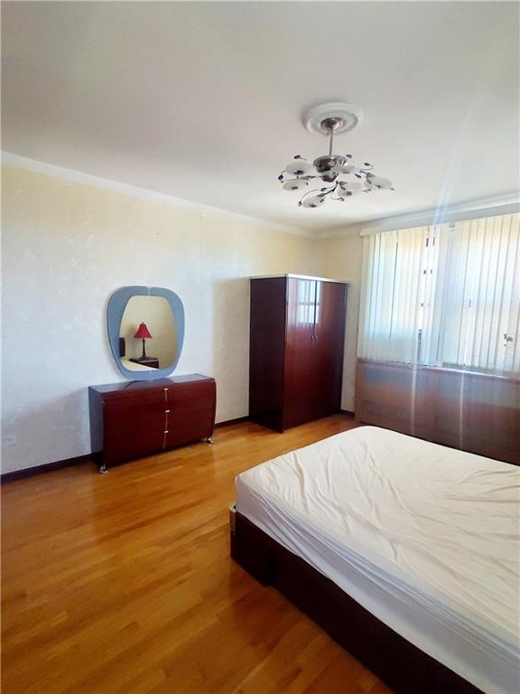 bedroom with hardwood / wood-style floors and crown molding