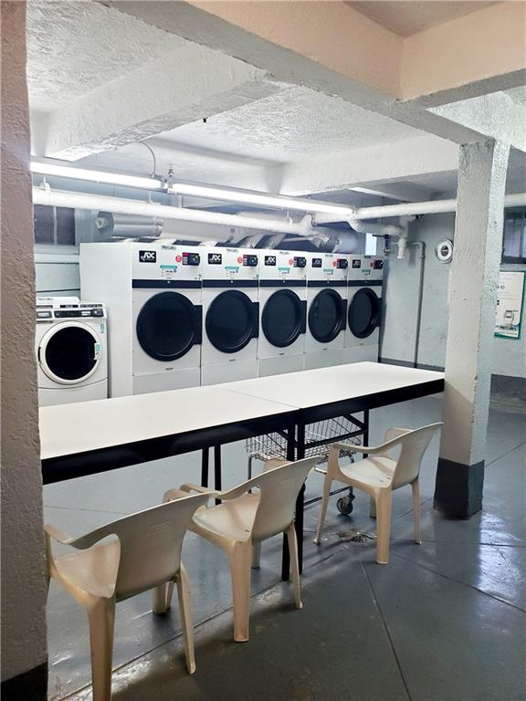 2375 Ocean Ave Unit 6K, Brooklyn, NY 11229 - shared laundry with separate washer and dryer and a textured ceiling
