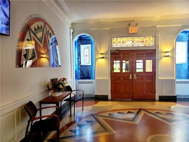 2375 Ocean Ave Unit 6K, Brooklyn, NY 11229 - foyer entrance with radiator, a decorative wall, crown molding, and wainscoting