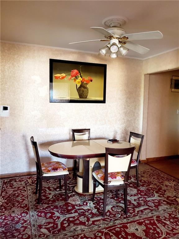 dining area featuring crown molding and ceiling fan