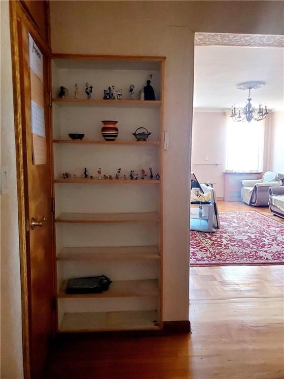 2375 Ocean Ave Unit 6K, Brooklyn, NY 11229 - hallway with wood finished floors and a chandelier