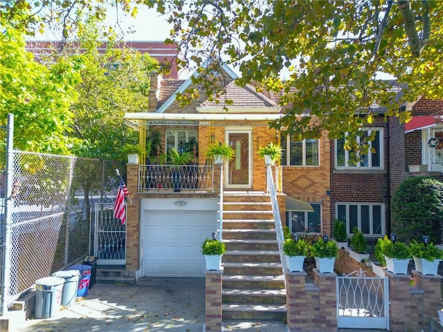 view of front facade with an attached garage, brick siding, fence, stairs, and driveway