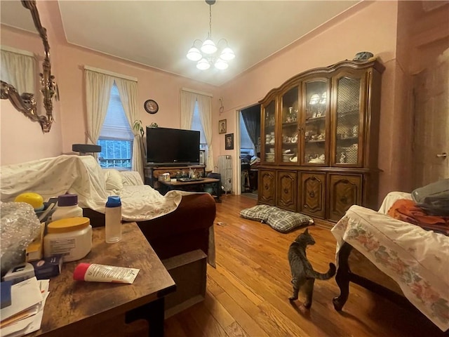 sitting room with hardwood / wood-style floors and a chandelier