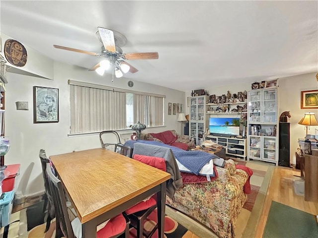 dining space with light hardwood / wood-style floors and ceiling fan