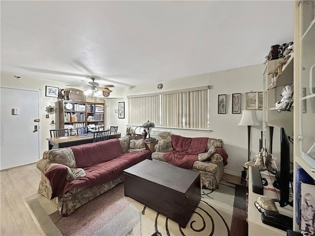 living room with ceiling fan and light wood-type flooring