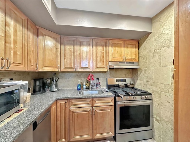 kitchen with appliances with stainless steel finishes, backsplash, and sink