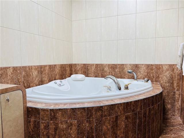 full bath featuring a garden tub and tile walls