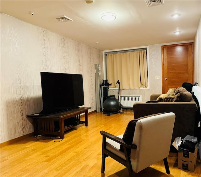 living room featuring radiator and light hardwood / wood-style floors