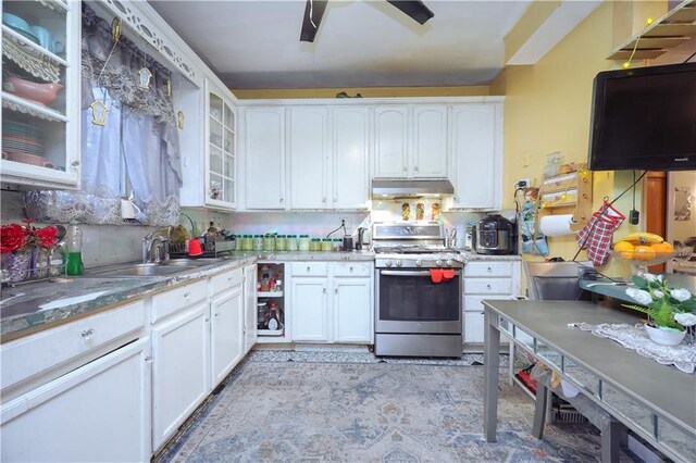 kitchen with tasteful backsplash, white cabinetry, stainless steel range with gas cooktop, and sink