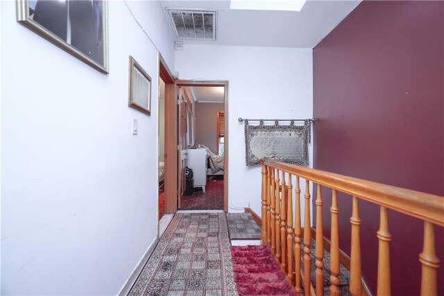 hall featuring carpet flooring