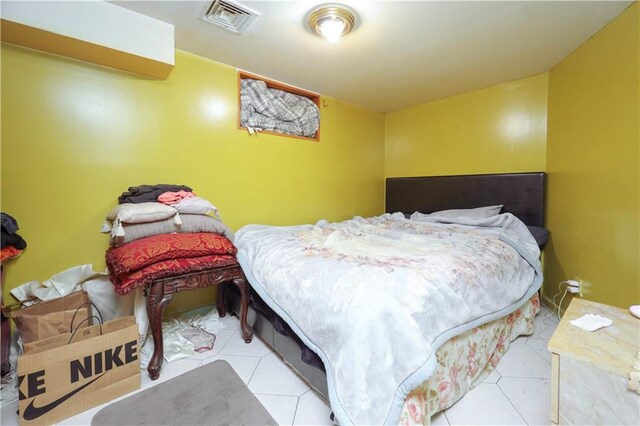 bedroom with light tile patterned floors